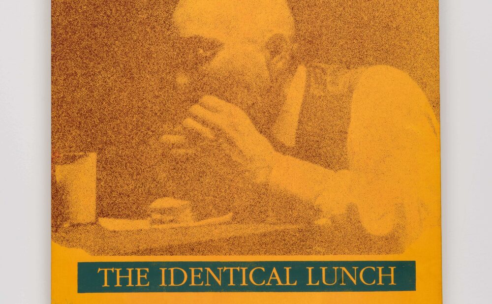 A stylized print of a person eating at a table in shades of orange and brown with green and yellow text. Alt-text generated by AI. Transcribed Text:  THE IDENTICAL LUNCH George Maciunas TUNA FISH COMPLIMENTS OF StarKist Foods, Inc.