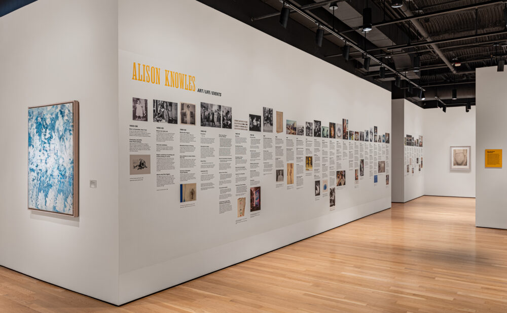 Gallery wall featuring an Alison Knowles timeline with photographs.