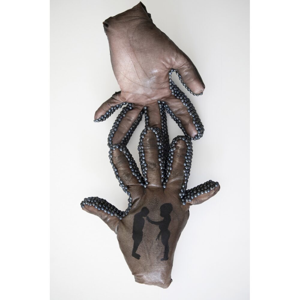 Two sculpted brown hands with bead-covered fingers, one hand has silhouettes of two figures on the palm.