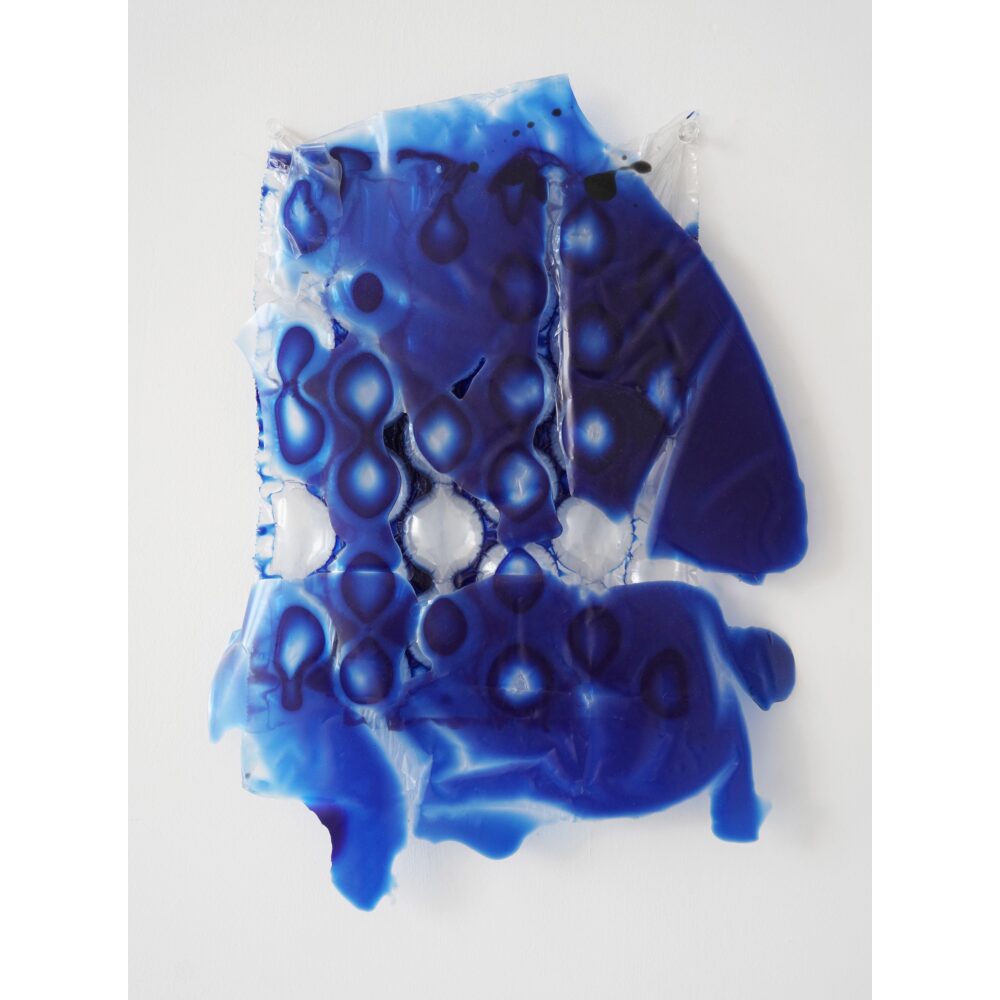 A sculpture comprised of a sheet of clear bubblewrap acting as a base for ultramarine blue resin that has hardened in the nooks and crannies of the plastic