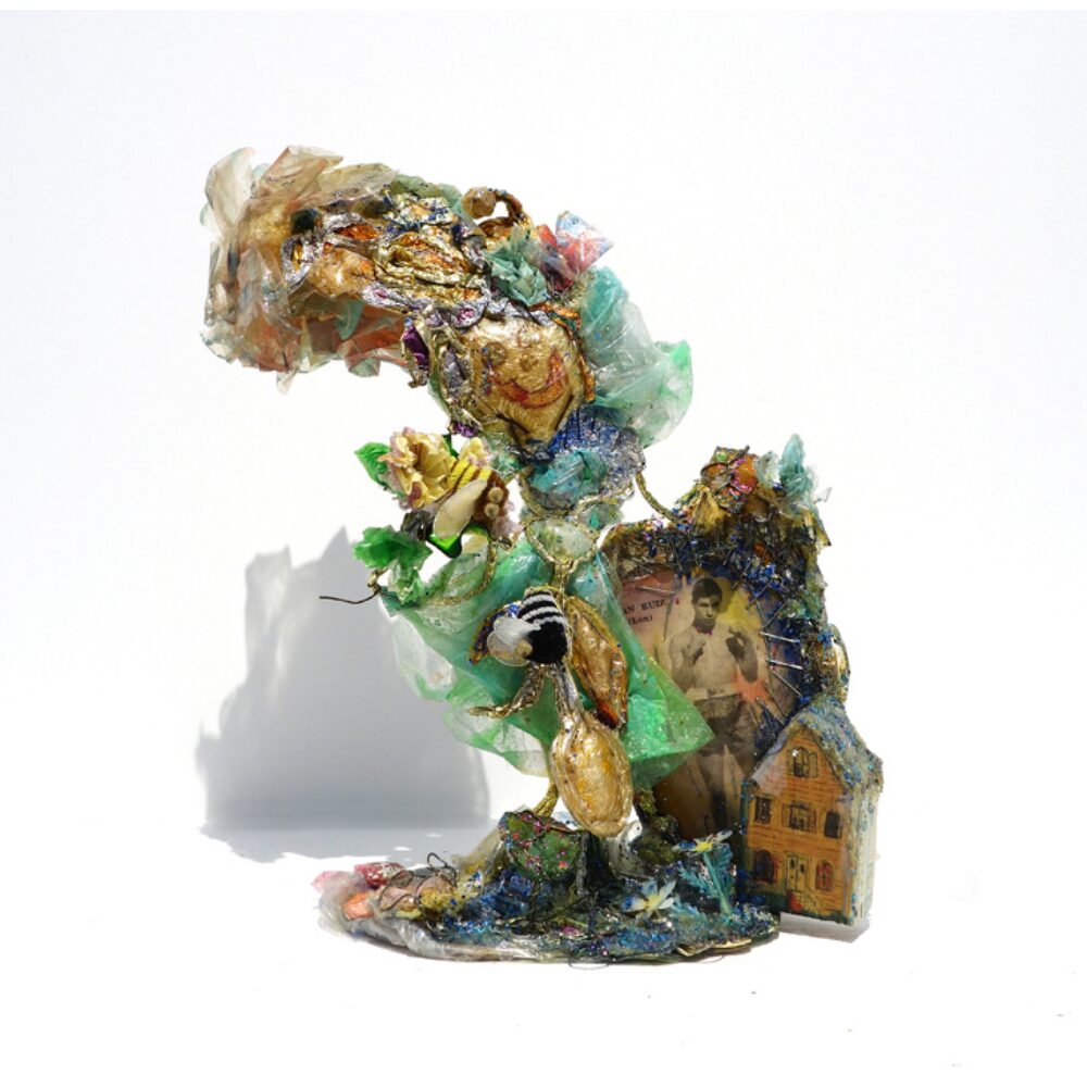 Vibrant, textured sculpture composed of colorful mixed-media elements on a white background. (Alt-text generated by AI)