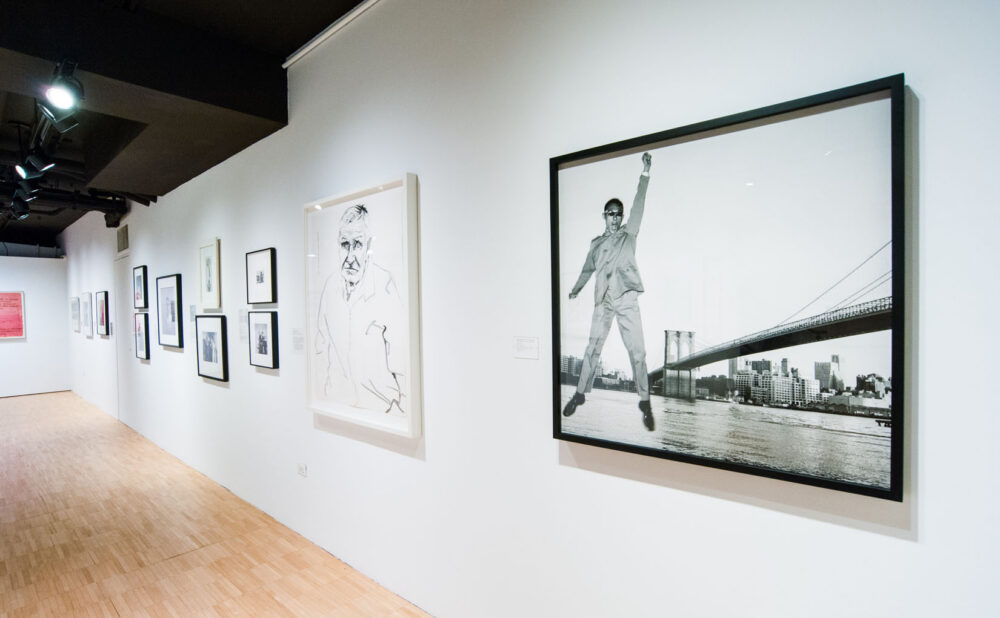 Wide hallway view showing a prominent framed black-and-white photograph on the far right wall. (Alt-text generated by AI)