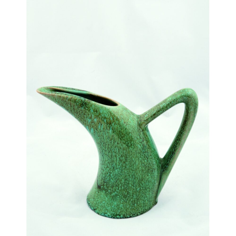 Sculptural ceramic pitcher in a matte green finish with a stylized, curved spout handle. (Alt-text generated by AI)