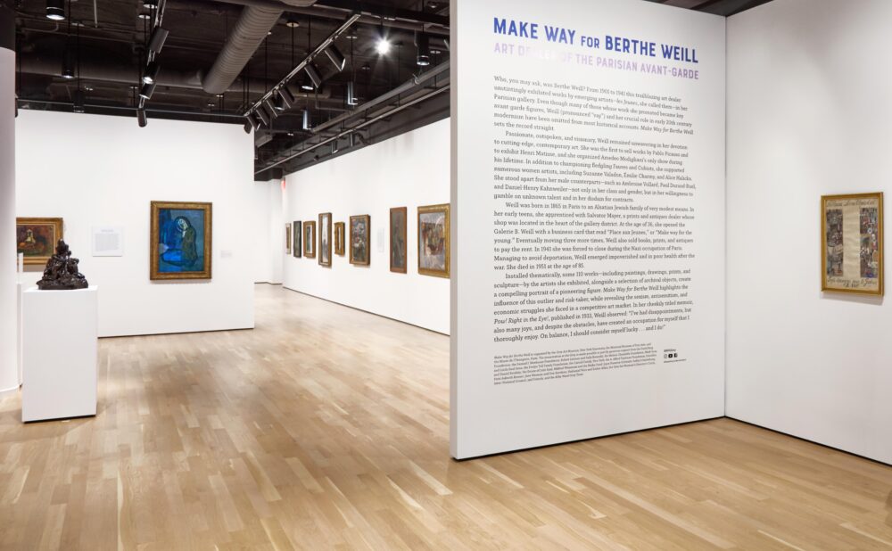 Art gallery with turn-of-the-century French paintings, sculptures, and a text wall titled "Make Way for Berthe Weill."
