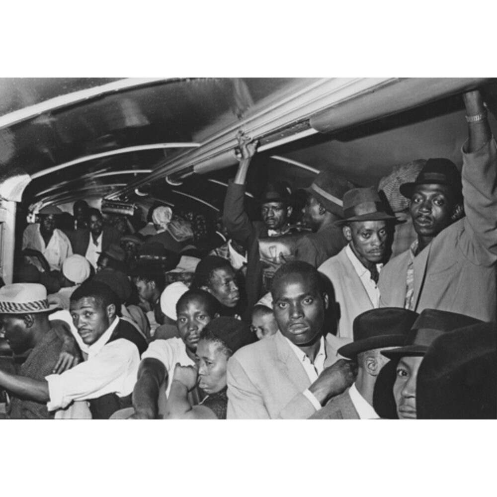 Candid interior photograph of passengers packed closely inside a crowded train car. (Alt-text generated by AI)