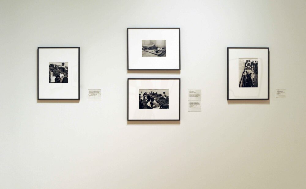 White gallery wall display featuring four framed black-and-white photographs arranged in a balanced geometric cluster. (Alt-text generated by AI)
