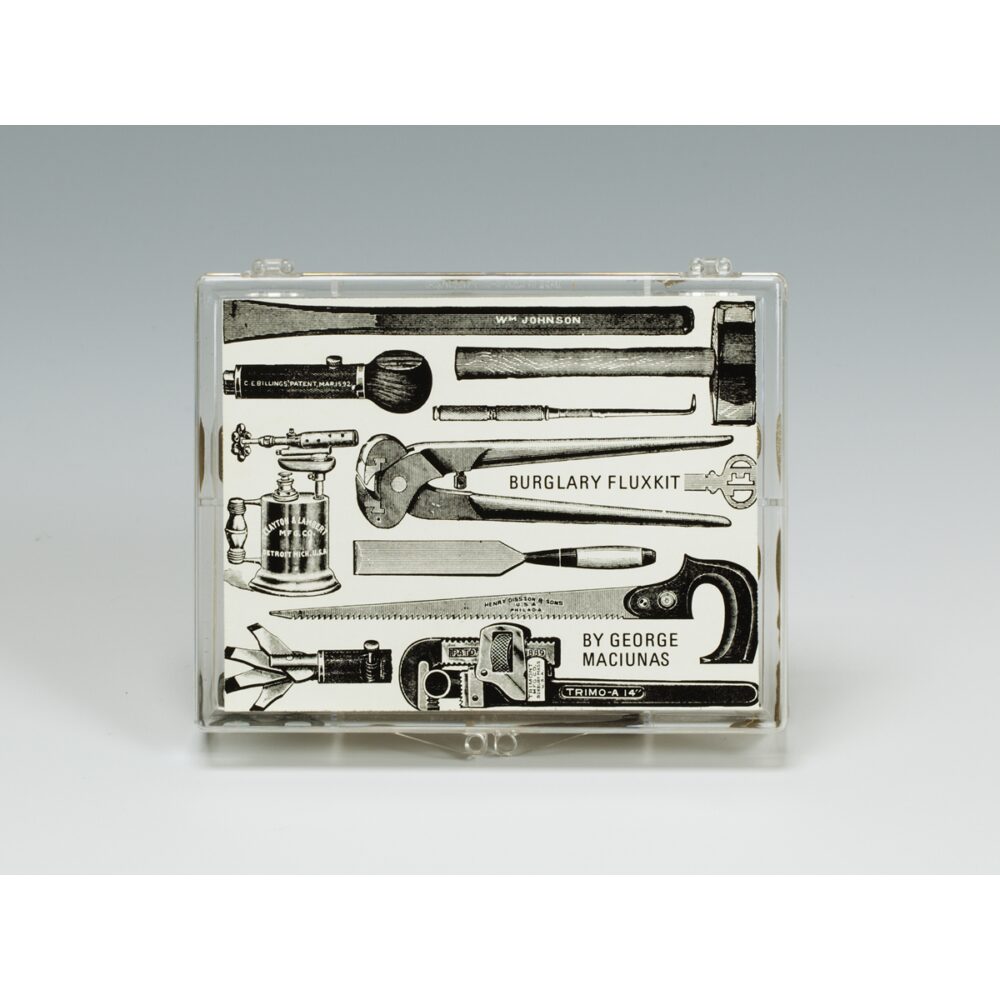 Transparent plastic case displaying a black-and-white collage of hand tools labeled “BURGLARY FLUXKIT” and “BY GEORGE MACIUNAS.” Alt text generated by AI.