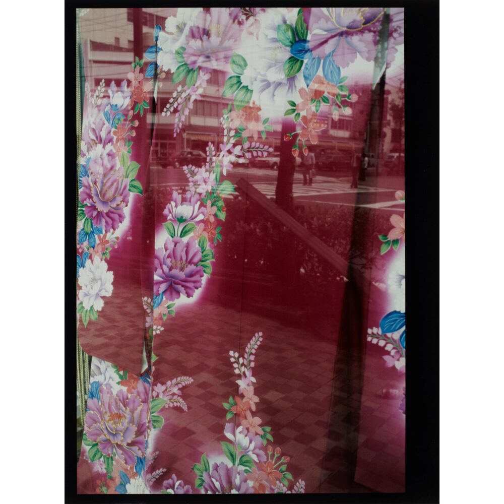 Vertical photographic print by Daido Moriyama showing blurred, abstract red patterns across a dark urban background. (Alt-text generated by AI)