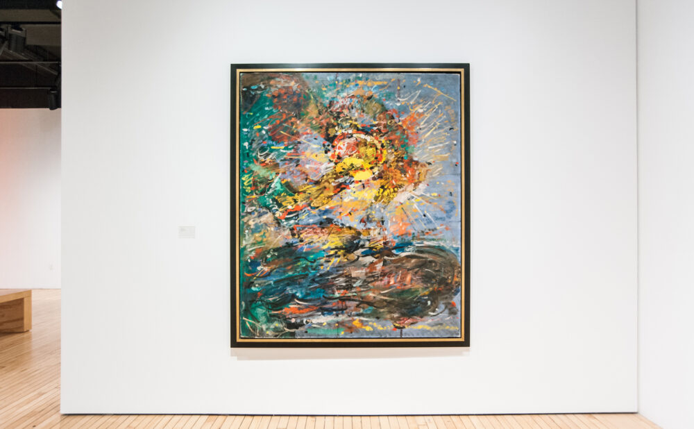 Centered view of a large, colorful abstract expressionist painting hanging on a white wall. (Alt-text generated by AI)