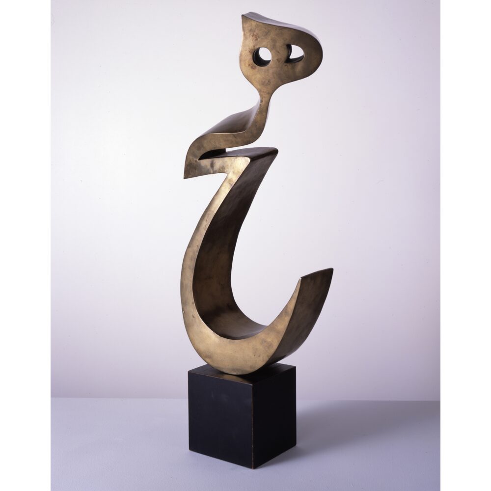 Bronze sculpture of a fluid, curved form resting on a dark rectangular base. (Alt-text generated by AI)