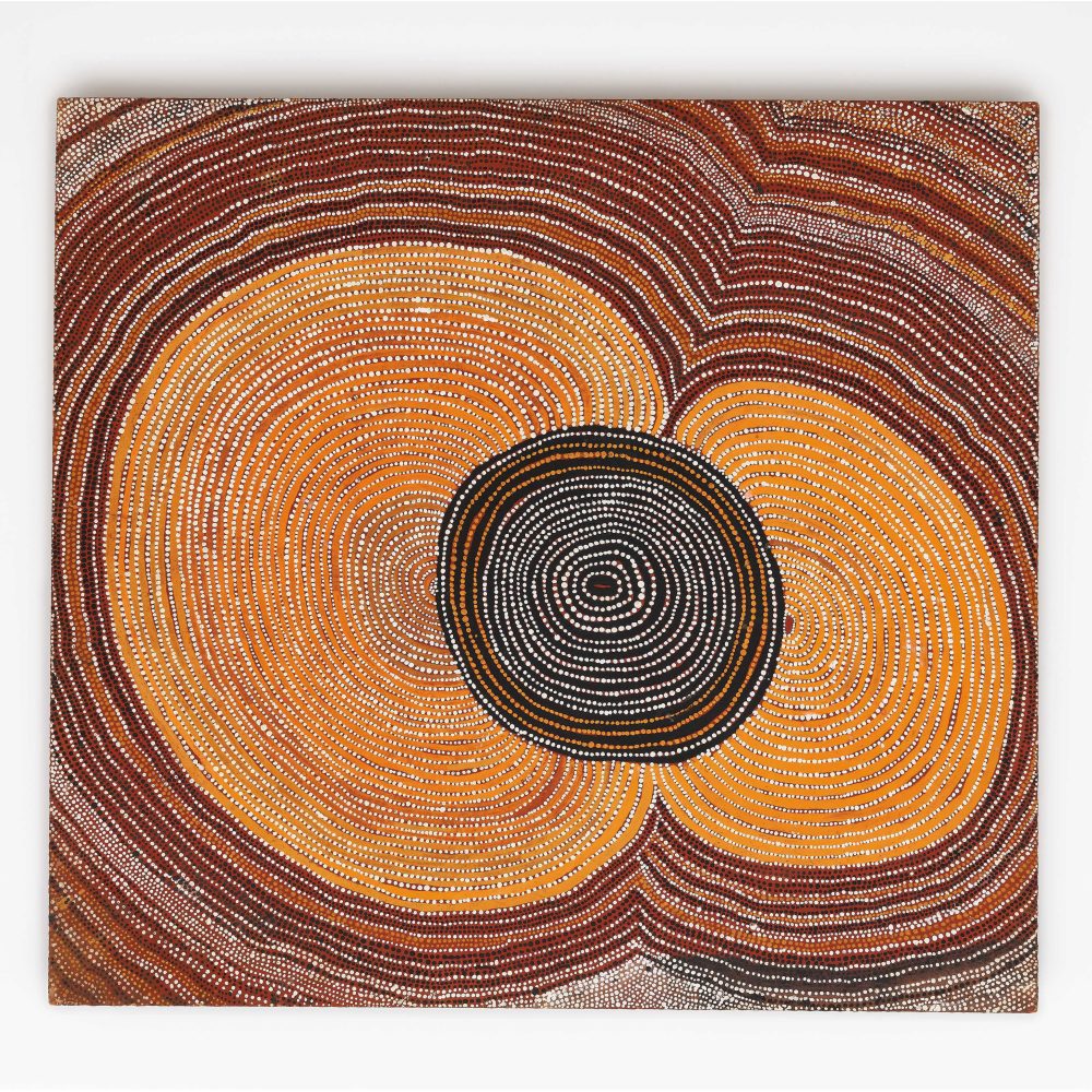 Abstract Aboriginal painting with concentric circles in black, white, yellow, orange, and reddish-brown dots.