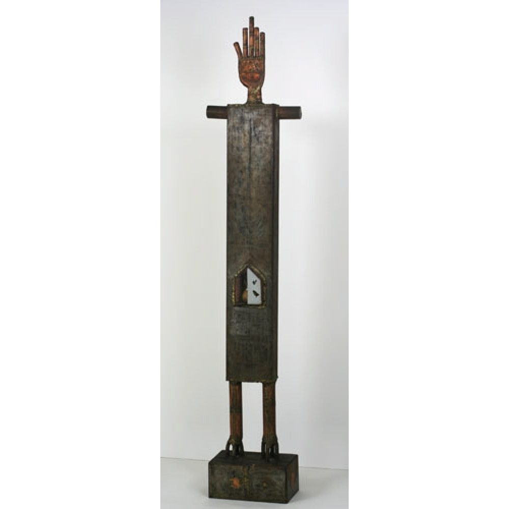 Tall abstract sculpture of a humanoid figure with clawed feet, a rectangular body, and raised hand perched atop