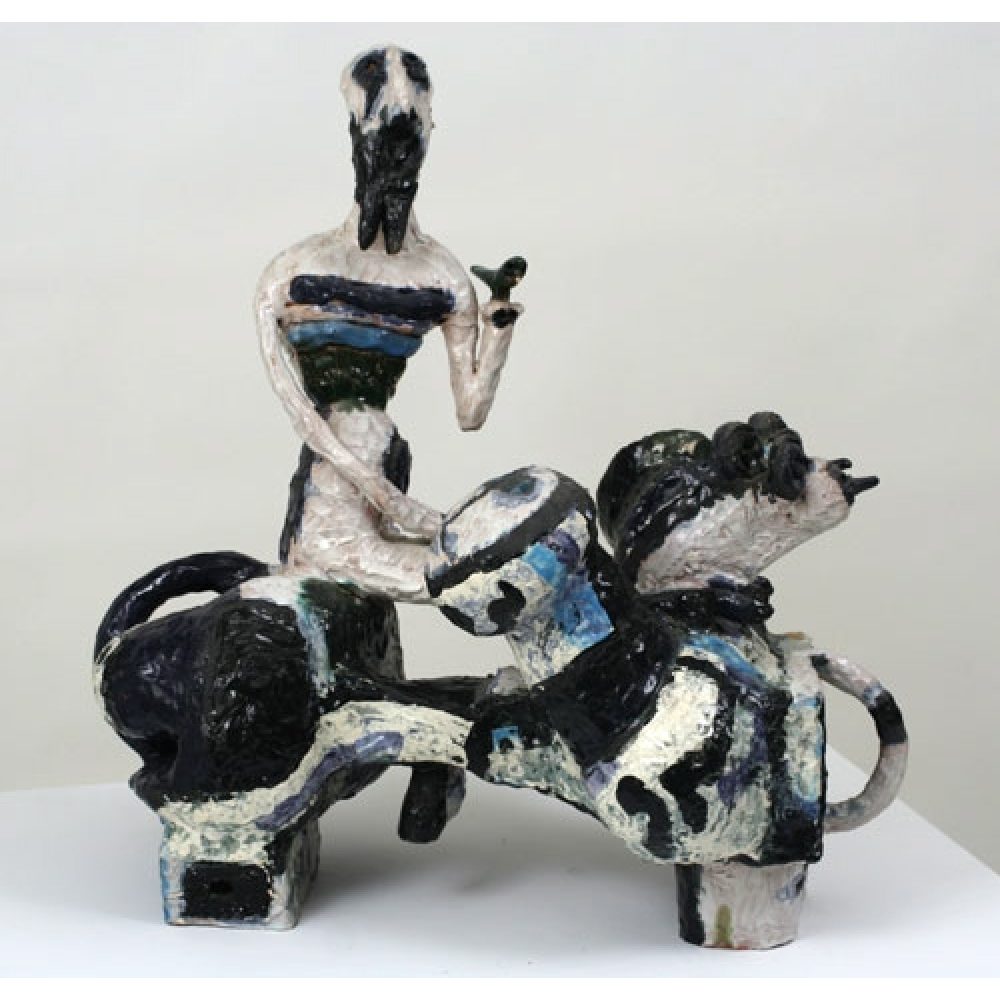 Abstract white, black, and blue ceramic sculpture of a humanoid figure with a bull-like creature.