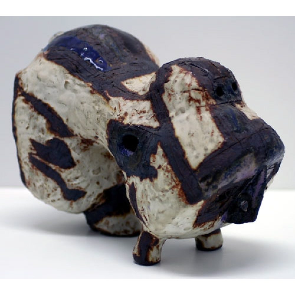 Abstract ceramic sculpture resembling a four-legged creature with white and dark blue-black markings.