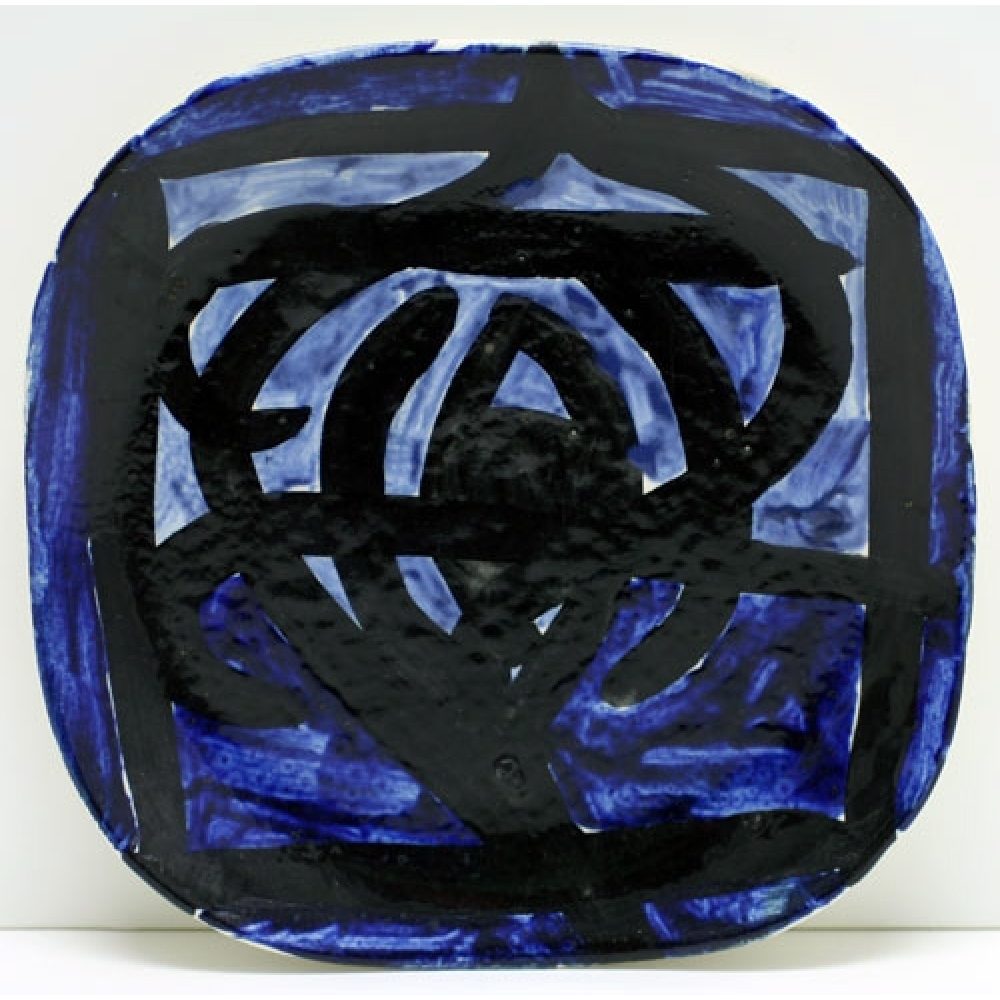 Ceramic plate with blue and black abstract patterns.