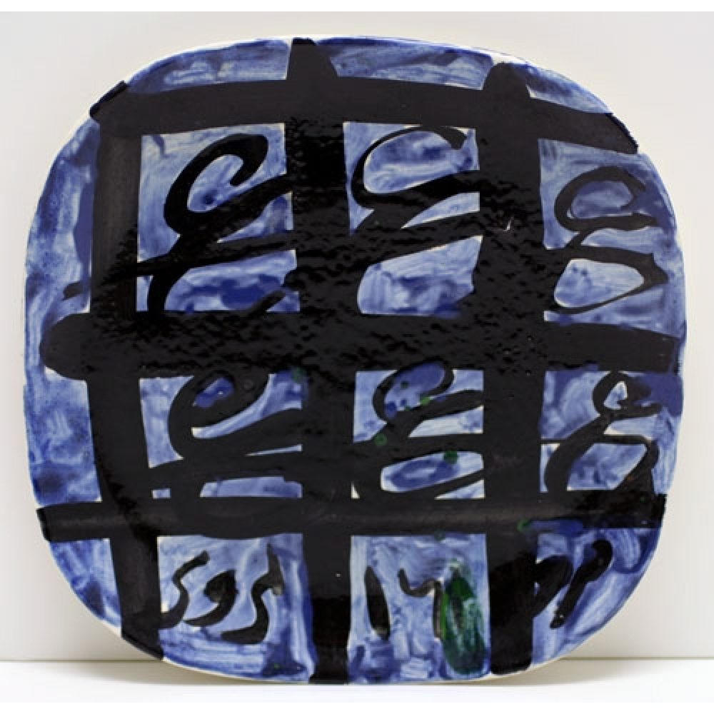 Square ceramic plate with blue and black abstract design.