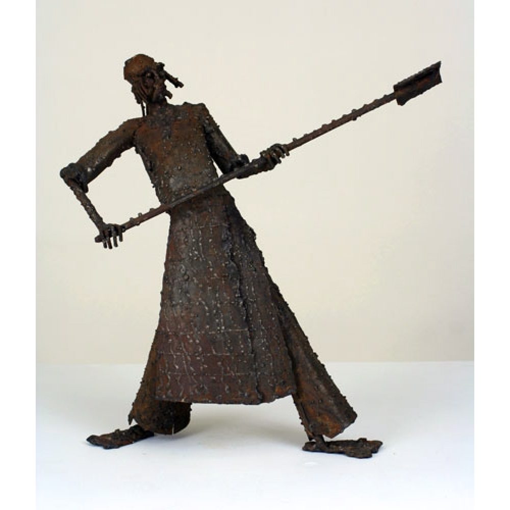 A metal sculpture of a human figure holding a spear-shaped object in a dynamic pose.