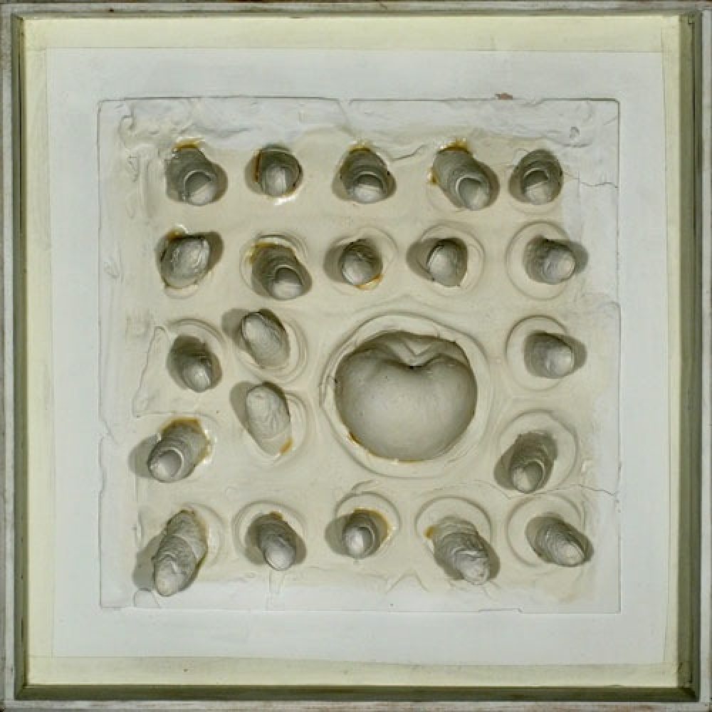Square artwork with rounded plaster apple forms embedded and arranged in an approximate grid pattern.