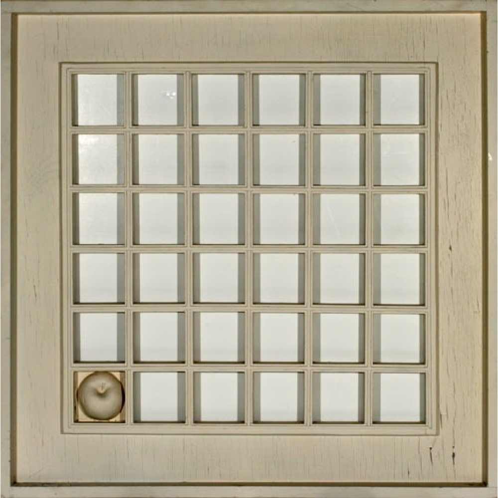 A grid of 36 squares with one distinct square inthe bottom left corner bearing an apple shape, set in a wooden frame.