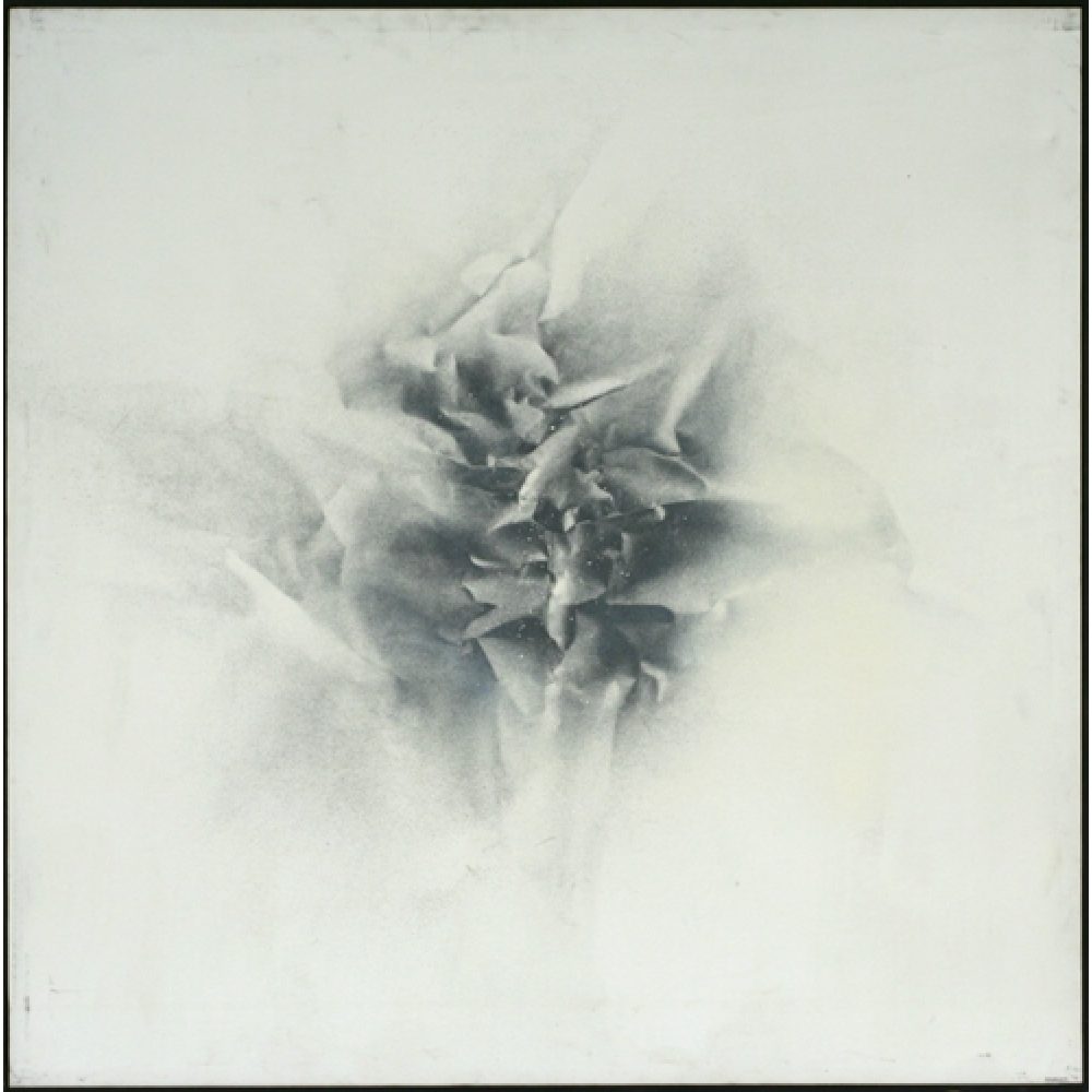 Monochrome artwork with a largely white background and crumpled texture effect central to the composition. The central area features a concentrated arrangement of folds and creases, forming a sharp, star-like pattern.