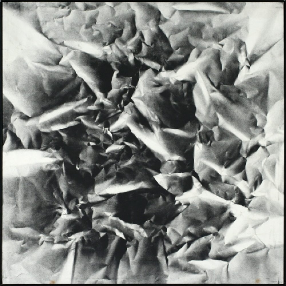 Monochrome artwork composed of a concentrated arrangement of folds and creases, with the painted shapes forming a crumpled paper texture.