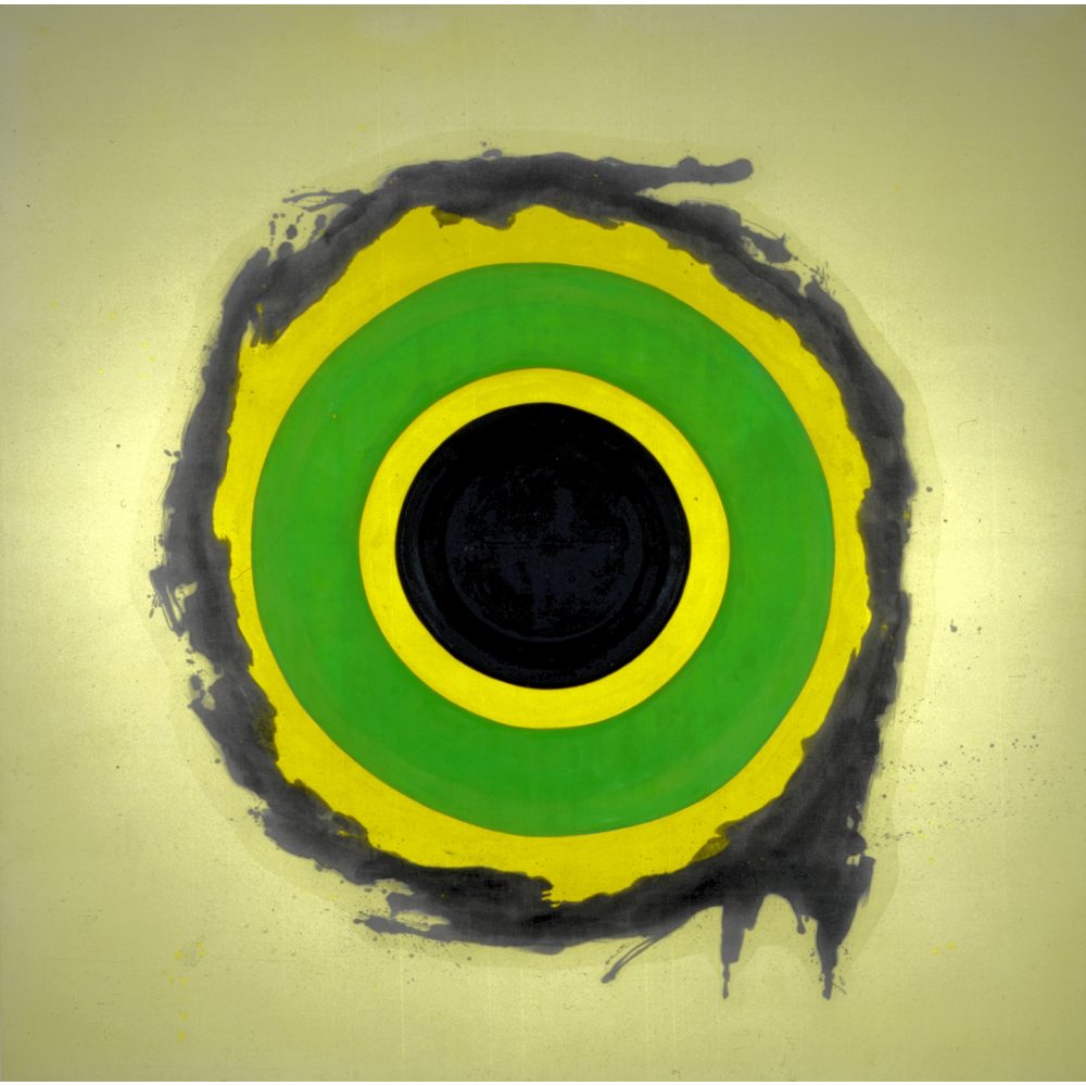 Painting of concentric circles with black, yellow, and green rings, with a splattered outer layer, on a light gray background. Alt-text generated by AI.