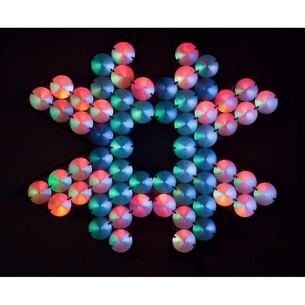 A star-shaped arrangement of colorful circular lights on a dark background. Alt-text generated by AI.