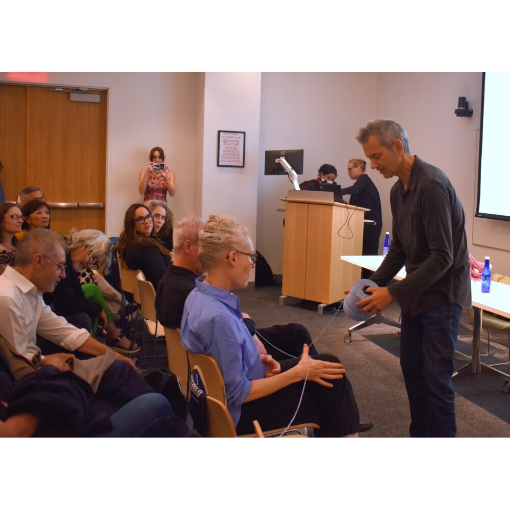 Audience members interacting with each other for a live event score using string.