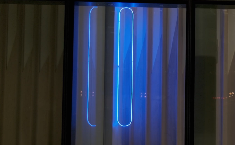 Oval blue neon light shining inside a dimly lit room.