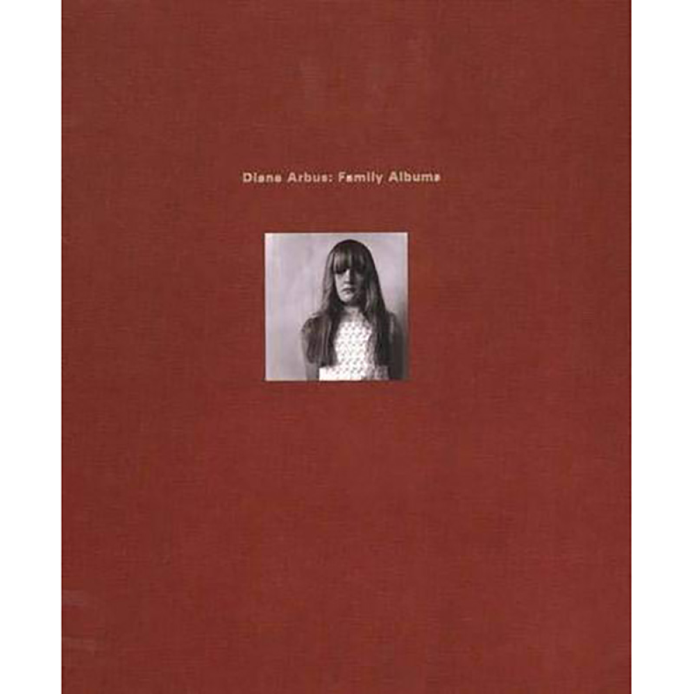 Brown book cover with a small black-and-white photo of a woman, titled "Diane Arbus: Family Albums."